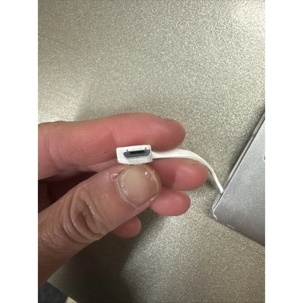 Ultra Slim portable charger silver with looks like Micro-USB cord see photos
